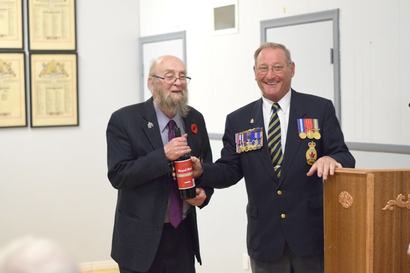 Emcee John Tiemstra (l) presents Legion padre David Pype for his long-term service as the branch &#8216;s spiritual leader.