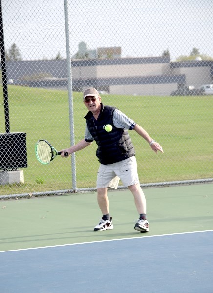 Ed Robinson returns service in a doubles match at the Barrhead Tennis Courts. Robinson was paired with Sharon Taylor in a mixed doubles match against Lois Schulz and Martin