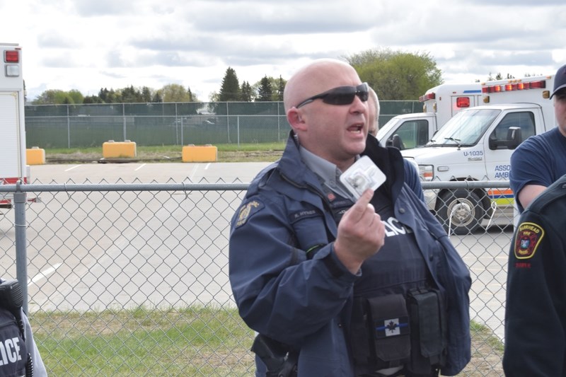 Const. Robert Hynes shows the students one of the Naxolone nasal spray kits all front line RCMP officers now carry.