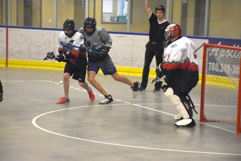 Midget Rock Blair Lobsinger looks for a pass under the watchful eye of a Fort Saskatchewan Rebel defender during the club &#8216;s 14-4 win over the Rebels at Rotary Spirit