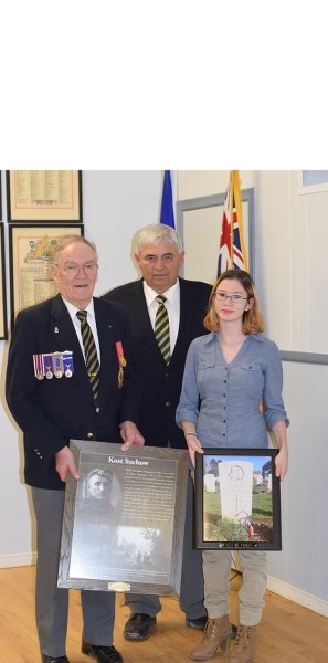 Beth McDonald (r) along with Steve Hoyda, Cherhill Royal Canadian Legion Branch president, present Barrhead Royal Canadian Legion president Chuck Mortimer with a picture and