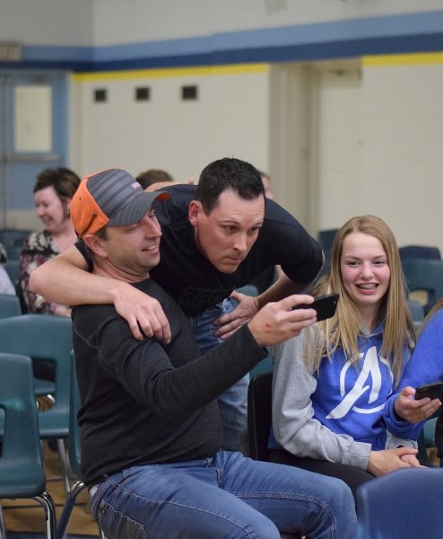 Orioles coach Doug Hanlan, who believes he just hit the winning homerun for the World Baseball Championship, takes a selfie with a devoted fan Jason Murrell.