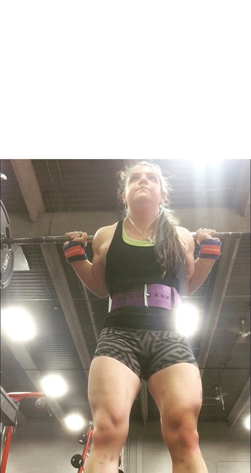 Danielle Philibert performing a squat lift during her training in a gym in Edmonton.