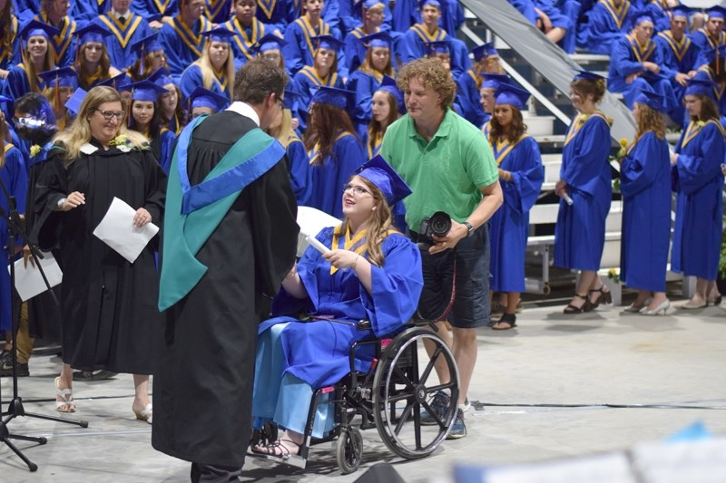 Emma Burt receives her diploma from principal Steven Kaplan.