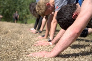 A group of young OCR competitors warm up during a Saturday practice session.