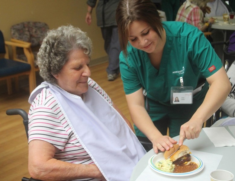 PHPS Health Care Aide student (r) Darby Grove helps Maryanne Hopley at the Barrhead Continuing Care Centre.