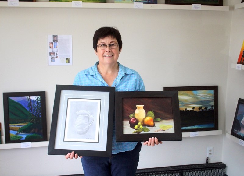 Rita VanRoodselaar shows two of her paintings which will be on display at the Barrhead Art Gallery from Aug. 4 to Aug. 26.