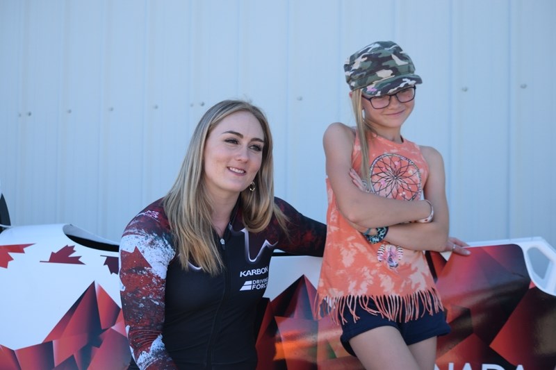 Melissa Lotholz poses with Charlie Bendzan, 9, in front of a national team training bobsled during Blue Heron Fair Days.