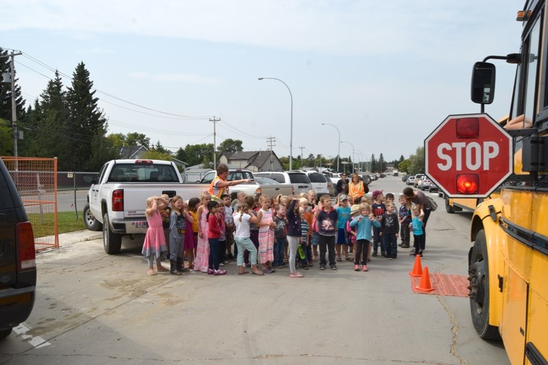 PHPS school bus driver Elaine Aikema show a group of about 30 soon to be kindergarten students the proper way to cross the street when meeting the school bus.