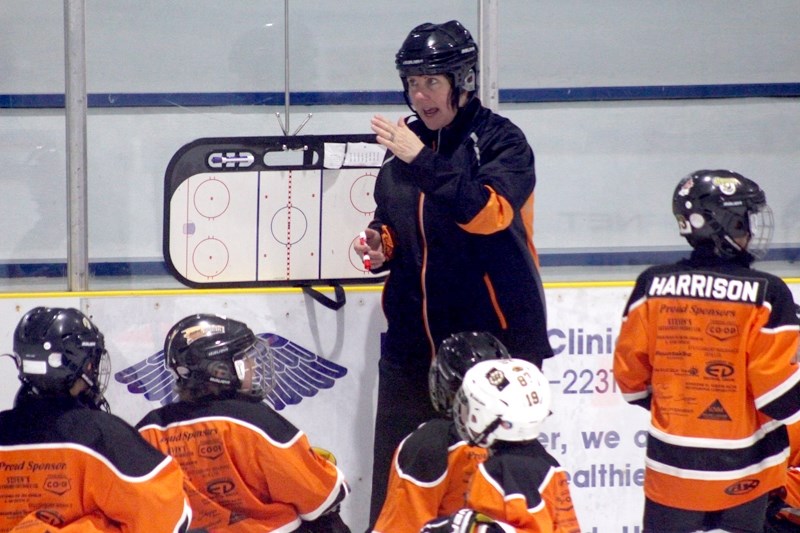 Pro North Hockey Camp coach Chris Driessen explains the basics of a particular hockey-related skill during the second week of hockey camp, pictured here Aug. 17.