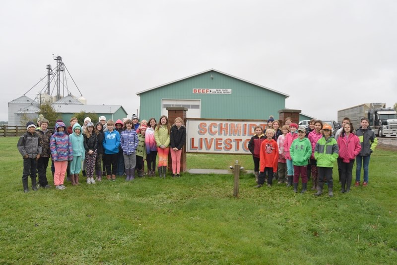 Andrea Wierenga (5A) and Kim Shapka &#8216;s (5-6F) classes posses for a group picture after touring Schmidt Livestock during an Agriculture Day tour.