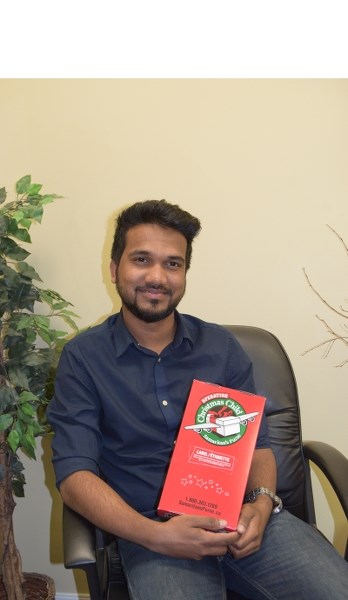 Jerry Amal Prasad poses with an Operation Christmas Child shoebox during the program &#8216;s official Sept. 24 Barrhead kickoff party at the Alliance Church.