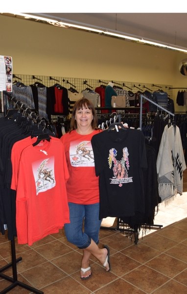 Barb Hodgins, owner of Barb &#8216;s Sewing, pictured here posing with a few examples of the High Performance Herd T-shirts which are a fundraiser for Canadian Olympic team