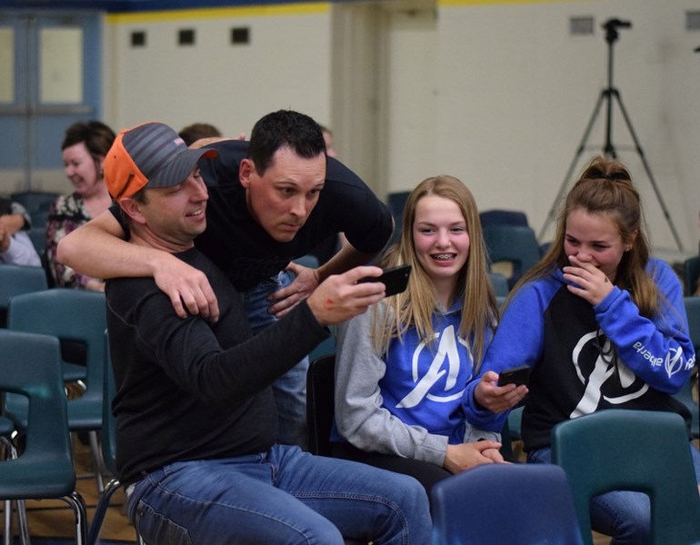 Orioles coach Doug Hanlan, who believes he just hit the winning homerun for the World Baseball Championship, takes a selfie with a devoted fan Jason Murrell during a