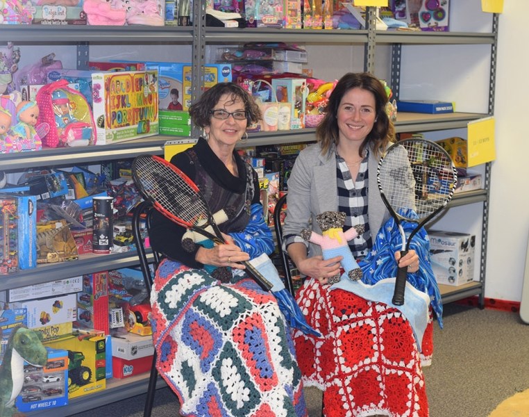 Barrhead and District FCSS Community and Development co-ordinator Ros Rudd (l) and Robin Kapler advocacy and support co-ordinator pose with some of the donations Santa