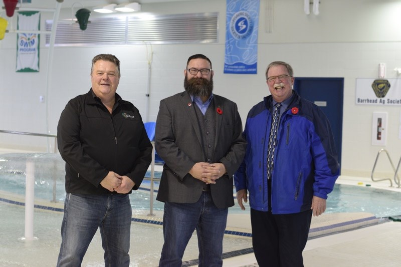 County of Barrhead reeve Doug Drozd (l) and Barrhead mayor Dave McKenzie give Municipal Affairs Minister Shaye Anderson a tour of the aquatics centre.