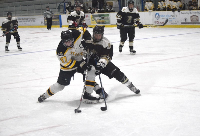 Mitchell Carstairs takes a wristshot while being defended by a Devon Driller.