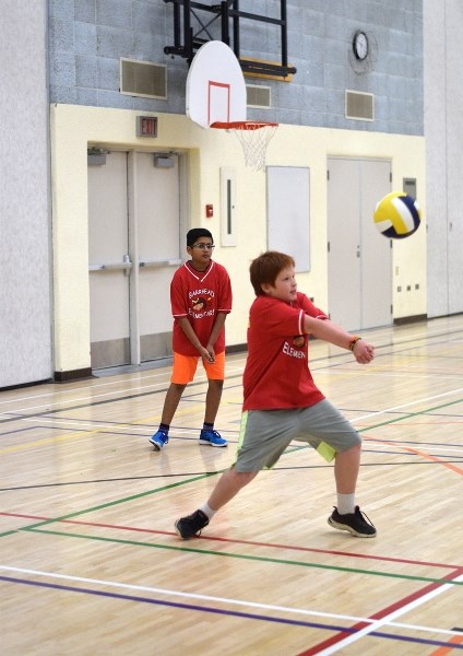 Barrhead Elementary School Bull Ryan Boutilier bumps the ball in a game against Swan Hills. His teammate Salman Gangji looks on.