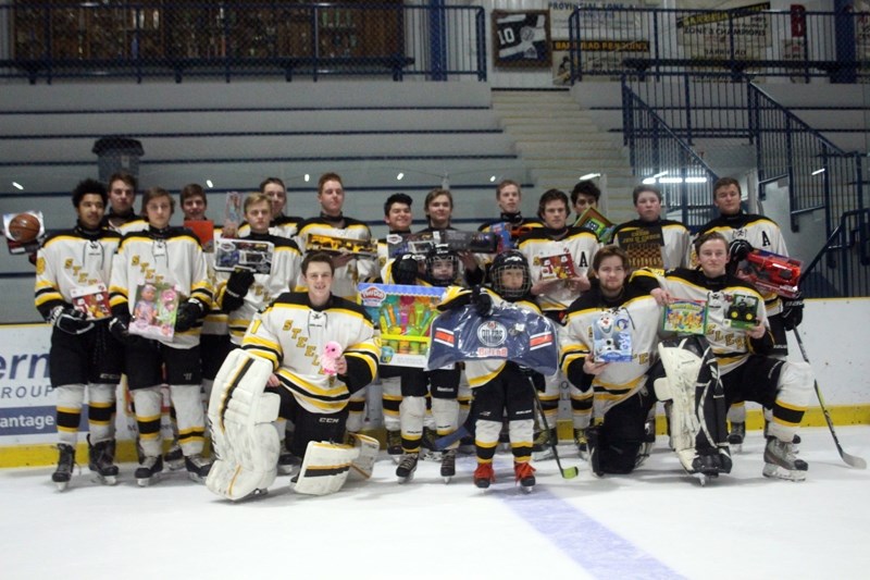 The 2017/2018 Barrhead &#8220;Midget &#8221; Steelers pose for a photo with toys donated by the community for FCSS &#8216; program, Santa &#8216;s Toy Box.