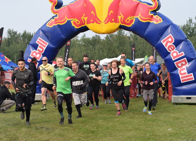 A group of competitors in the open class begin their obstacle course adventure.