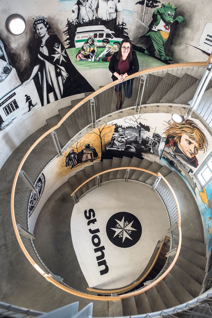  Meagan Taylor, office administrator of the St. John Ambulance Alberta Council, in a spiral stairwell depicting the history of the St. John Ambulance at their facility in Edmonton February 13, 2019.