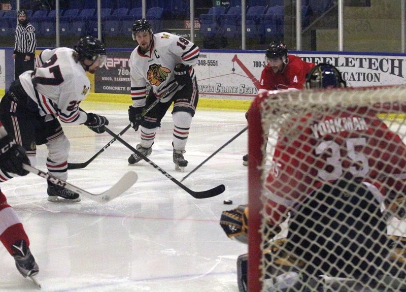 Westlock Warriors Ryan Nelles attempts to backhand a shot while captain Mike Ivey readies for the rebound during a 6-3 loss to the Eckville Eagles Jan. 13. The club will now