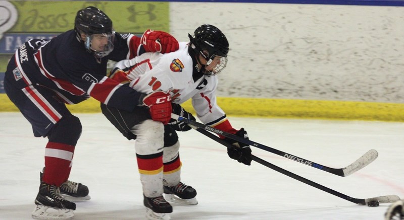 Midget Warriors captain Sheldon McCoy does his best to get around the Wetaskiwin defender Feb. 2 at the Rotary Spirit Centre. The Warriors dropped that game 3-1, but came