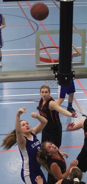 St. Mary Shark Mackenzie Lunger shoots over a Hay Lakes defender during the club’s 58-51 loss in the final of the Cathy Mitchell Memorial Tournament played Feb. 24 at the