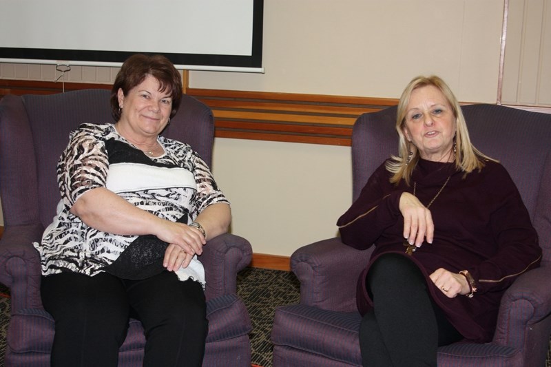 Women&#8217;s Symposium organizers Leslie Phillips (left) and Sylvia Yoder share a moment at the completion of the event March 8 at the Westlock Inn. This was the fifth