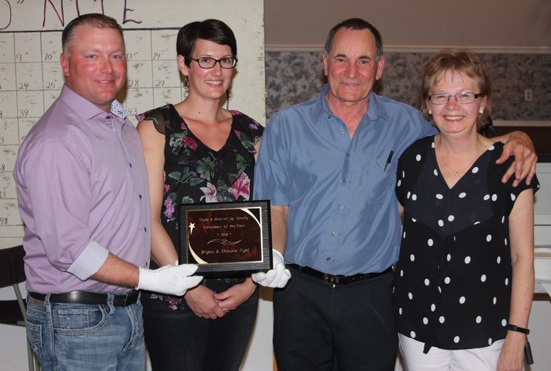 Bryan and Shauna Nyal (left) accepted the Clyde and District Ag Society&#8217;s Volunteer of the Year Award from last year&#8217;s winners Jim and Darcy Rau April 28 at the