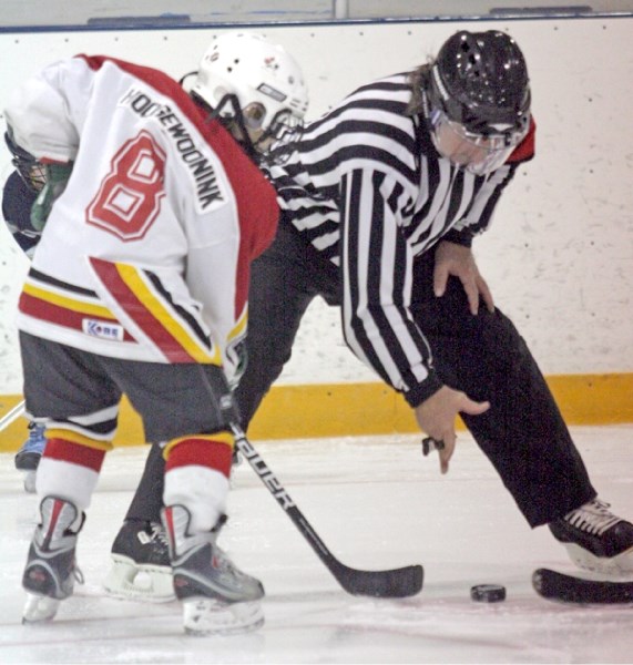 Local ref Brynne Towle drops the puck during a Saturday pee wee tilt at Jubilee Arena.