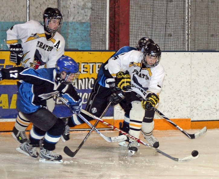 The Barr-West Pirates&#8217; Cole Walker (left) and Tyson Chizma scramble for the puck during last Monday&#8217;s matchup against the Slave Lake Thunder. Although the Pirates 