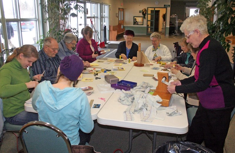 A group of dedicated volunteers meets the first Tuesday of every month at the Westlock Gospel Chapel to make calendars and bandages to send to Chad and Zambia. Former