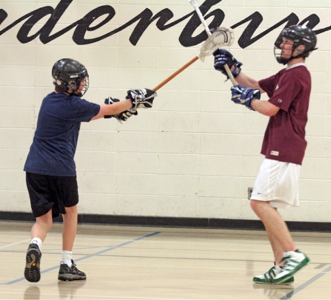 Jason Peyre (left) tries to steal the ball from Eric Hardinge at the Westlock Lacrosse Association&#8217;s first drop-in and try-it session on Jan. 7 at R.F. Staples.