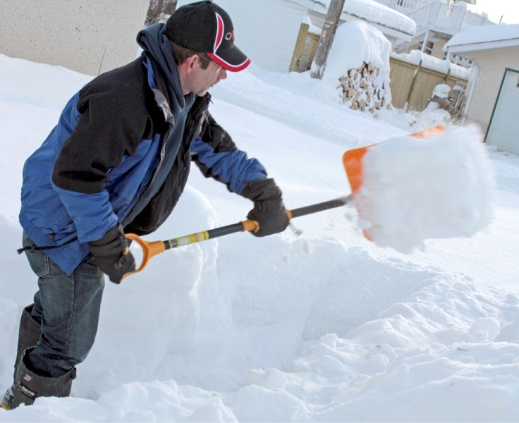 Miles White shovels out his daughter&#8217;s backyard on Jan. 18. White was digging out after the big snow dump the town received over the previous weekend.