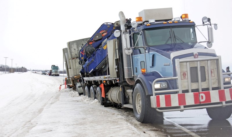 Robert Schaller&#8217;s semi trailer unit slid sideways off the icy Highway 18 Wednesday morning.