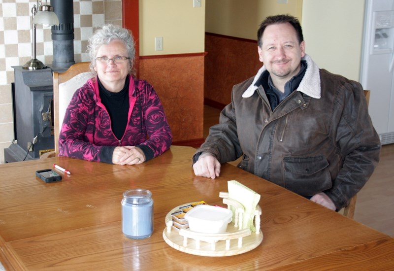 Sparrow&#8217;s Hope house parent Irma Kryger sits in the shelter&#8217;s dining room with Youth for Christ director Ben Kellert.