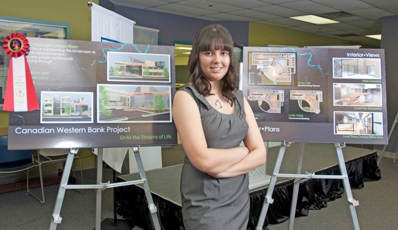 Second-year architectural technology student Michelle Wiese, who hails from Westlock, poses with the placards showing her design for the Canadian Western Bank&#8217;s new
