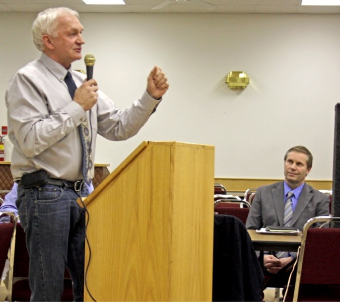 Wildrose Alliance MLA Paul Hinman (right) listens intently while Vegreville-Wainwright candidate Danny Hozack speaks in Westlock last week.