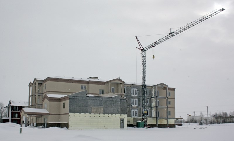 This unfinished condominium started by Melvac Construction, which went bankrupt before it completed the project, sits unfinished near the McDonald&#8217;s. A group of local