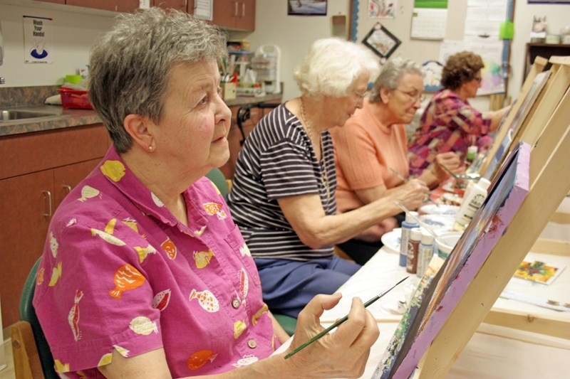 Artists packed the activity room at the Smithfield Lodge last week, where they were busily working on new paintings. Denise Pipke (left), June Hobart, Jeanette Galinowski and 