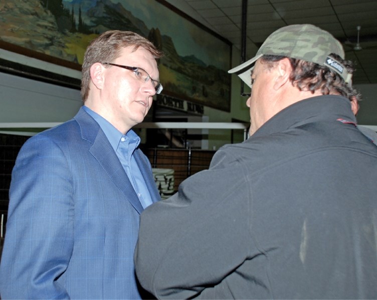 Following the information meeting held at Nilsson Bros. at Clyde last Tuesday evening, presenter Keith Wilson, at left, chats with Newbrook area cattleman Bernie Regner.