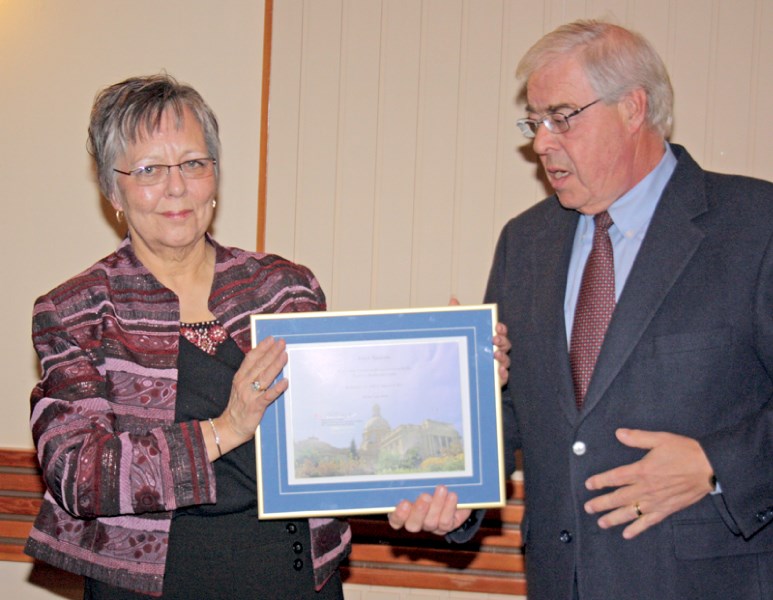 MLA Ken Kowalski presents Joyce Nadeau with a plaque commemorating her 43 years of service as a nurse in Westlock at her retirement party last Friday night. Nadeau has worked 
