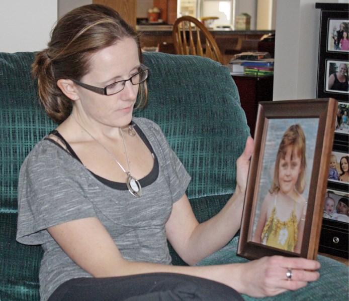 Lisa Boulerice holds a photo of her daughter Kali, who was diagnosed with a brain tumour when she was three and passed away two years later.