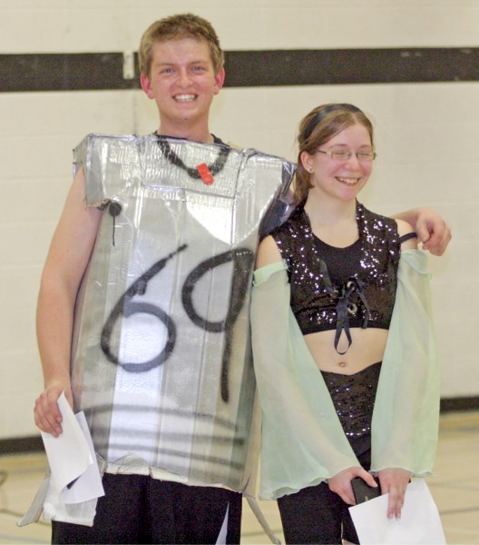 Cody Erdmann as a robot and Sandra Rubik as princess Jasmine laugh after being awarded the best-dressed boy and girl awards at the annual R.F. Staples Dress-Up Basketball