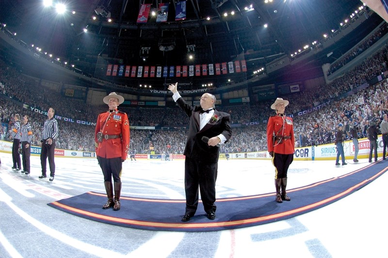 Paul Lorieau, clad in his trademark tuxedo, waves to the crowd during his final performance at the Edmonton Oilers&#8217; home game on April 9. Lorieau retired after 30 years 