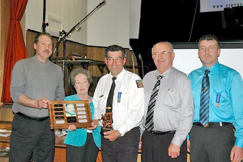 Glenn Latimer award winner Harvey Provost (centre) receives the plaque from Gail Latimer, and was joined by county public works Supt. Dennis Mueller (left), county reeve