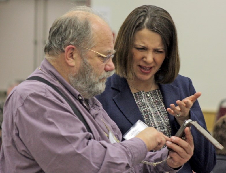 Wildrose Alliance leader Danielle Smith reacts as Dr. Michael Smith raises some of his concerns about the healthcare system as a party fundraiser in Westlock last Tuesday.