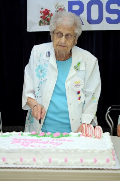 Rosey VanHove makes the first cut in her 100th birthday cake May 15 at the Westlock Legion.