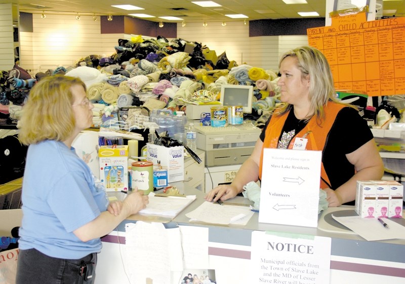 The community has been generous with support for the Slave Lake evacuees who have found themselves in Westlock. Above, a mountain of donations can be seen as volunteers Paddy 